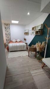 a bedroom with a bed and a couch in a room at Studio Chambre double RDC in Chazelles-sur-Lyon