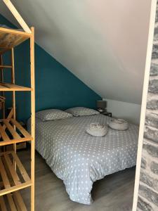 a small bedroom with a bed and a ladder at Studio fécamp in Fécamp