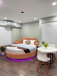 a bedroom with a large bed and two tables at Family Inn - Airport Hotel in Dhaka