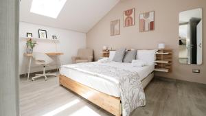 a bedroom with a large white bed and a desk at Botanic Apartments - Suite in Naples