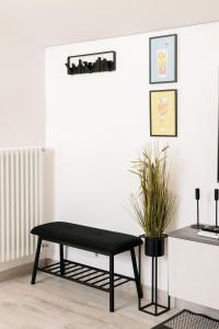 a black bench sitting in a living room at Botanic Apartments - Suite in Naples