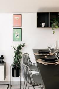a dining room table with two chairs and a plant at Botanic Apartments - Suite in Naples