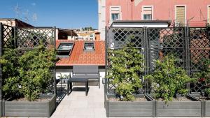 a balcony with a bench and trees on a building at Botanic Apartments - Suite in Naples