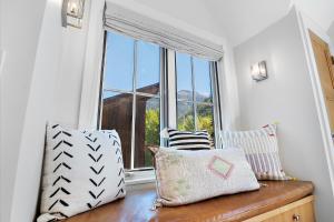 a window in a room with pillows on a bench at 330 W Pacific B townhouse in Telluride