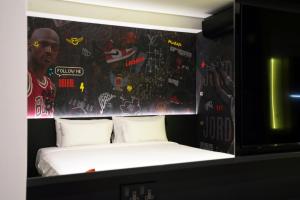 a bedroom with a bed with graffiti on the wall at SO City Hotel Adults Only in St. Julianʼs