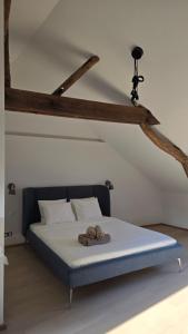 a bedroom with a bed with two towels on it at Botanique Appart-Hôtel in Lens