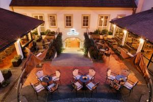 
an outdoor dining area with tables and chairs and umbrellas at Hotel Jägerhorn in Zagreb
