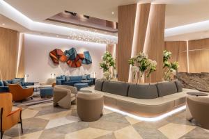 a lobby of a hotel with a couch and chairs at Sheraton Mall of the Emirates Hotel, Dubai in Dubai