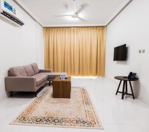 a living room with a couch and a table at Liza Hotel in Muscat