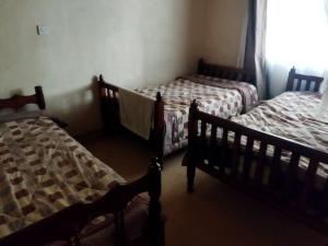Кровать или кровати в номере Pega Tours Home Stay
