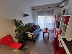 a living room with red chairs and a couch at Studio et stationnement offert centre hyeres in Hyères