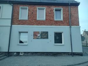 a building with a sign on the side of it at Noclegi Czentorycki 3 in Tyniec nad Ślęzą