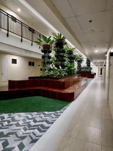 a lobby with a row of potted plants at Matina Enclaves 2BR with Wifi Near SM Mall in Davao City +69 photos