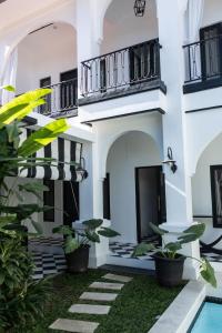 a courtyard of a house with plants and a swimming pool at Saige House - Room in Shared Villa in Canggu +14 photos