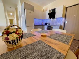 a dining room table with a basket of fruit on it at Kalamata.House - Sunny and modern apartment with view! in Kalamata