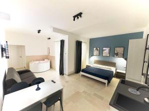 a living room with a bed and a couch at Philia Rooms in Leporano Marina