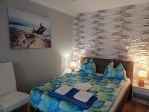 a bedroom with a bed with blue pillows at Morski Brzeg in Świnoujście