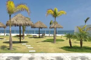 a picnic area with palm trees and a beach at Beach, Mountain and More! in Nueva Gorgona