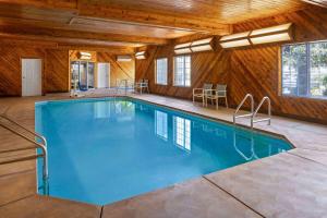 a swimming pool in a house with wooden walls at La Quinta by Wyndham Bakersfield North in Bakersfield