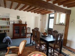 a living room with a dining room table and chairs at Maison confortable et bien équipée au calme in Villemeux-sur-Eure