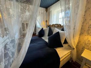 a bedroom with a large bed with curtains at Rold Gl Kro in Arden +65 photos