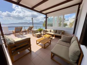 a living room with couches and a view of the ocean at Maya Mallis in Adamas