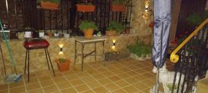 a room with a tiled floor with potted plants at Casas Rurales el Olmo in Riópar Viejo +31 photos