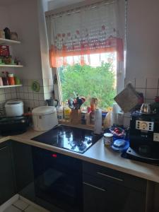 a kitchen with a sink and a stove top oven at Private Zimmer in einer Wohngemeinschaft für die Nacht in der Nähe des Flughafens Halle Leipzig in Schkeuditz +7 photos
