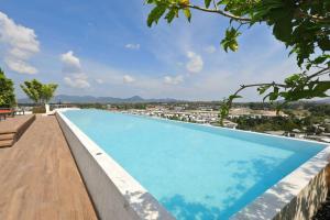 a large swimming pool on the roof of a building at Sky Park condo 1 bedroom in Laguna Phuket