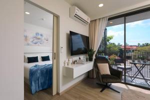 a bedroom with a bed and a balcony at Sky Park condo 1 bedroom in Laguna Phuket