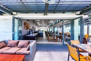 a living room with a couch and tables and chairs at Ocean Apartment Two Bedrooms in Danang