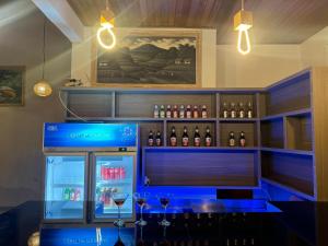 a bar with a blue counter with wine bottles at Kelingking Parama Resort in Nusa Penida