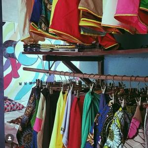 a bunch of clothes hanging on a rack at Popbeachclub Suites ilashe in Ibasa +36 photos