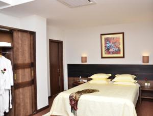 a bedroom with a large bed in a room at Boutique Hotel Argo in Kutaisi