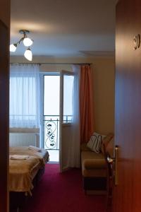 a hotel room with a bed and a balcony at OW Patryn in Karpacz