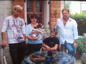 a group of people standing around a table with a dog at Guesthouse Casa Nova in Poreč