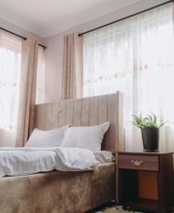 ein Bett in einem Schlafzimmer mit einem großen Fenster in der Unterkunft Arusha Kwetu Villa in Sokon