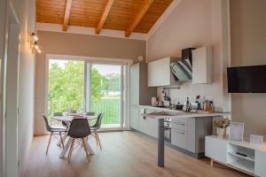 a kitchen and dining room with a table and chairs at Casa Martinèt- Prestogioso 2 suite 2 bagni privati con terrazza 35m in Bra