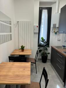 una cucina con tavolo, sedie e lavandino di Pinturicchio 21 a Milano