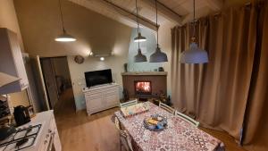 a living room with a table and a fireplace at Casa Nonna Ada in Cisterna dʼAsti
