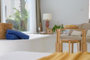 a living room with a couch and a table and chairs at AQUABLANCA Suite Love Deluxe en Punta Mujeres in Punta de Mujeres +20 photos