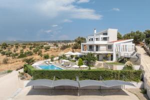an aerial view of a house with a swimming pool at Sensi resort Nikiti in Nikiti