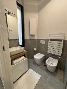 un bagno con lavandino, water e specchio di Pinturicchio 21 a Milano Altre 19 foto