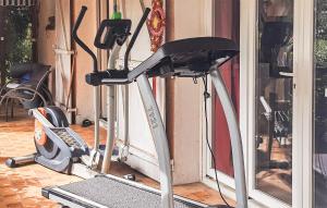 a gym with a treadmill next to a door at Beautiful Home In St Julien De Peyrolas in Saint-Julien-de-Peyrolas