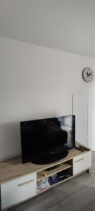 a flat screen tv sitting on top of a entertainment center at la Besotte 2 pièces 40 m2 in Esbly