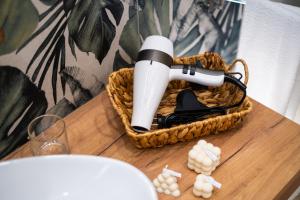 a hair dryer in a basket on a table at Euphemia Glamour Apartment in Reggio Calabria