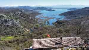 a view of a valley with a river and mountains at Panorama Stone Houses - Skadar Lake in Cetinje