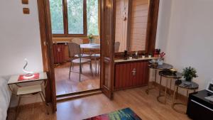a small room with a table and a dining room at Feeria National Parc in Bucharest