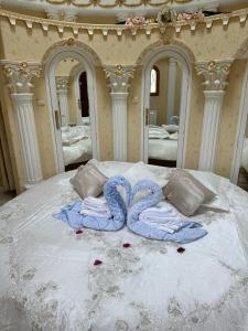 a bed with two towels on top of it at Domaine Athéna in Pitres