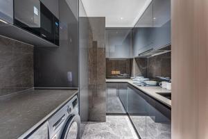 a large kitchen with stainless steel appliances and counters at BaiYue Apartment - Zhujiang New City Guangzhou in Guangzhou +35 photos